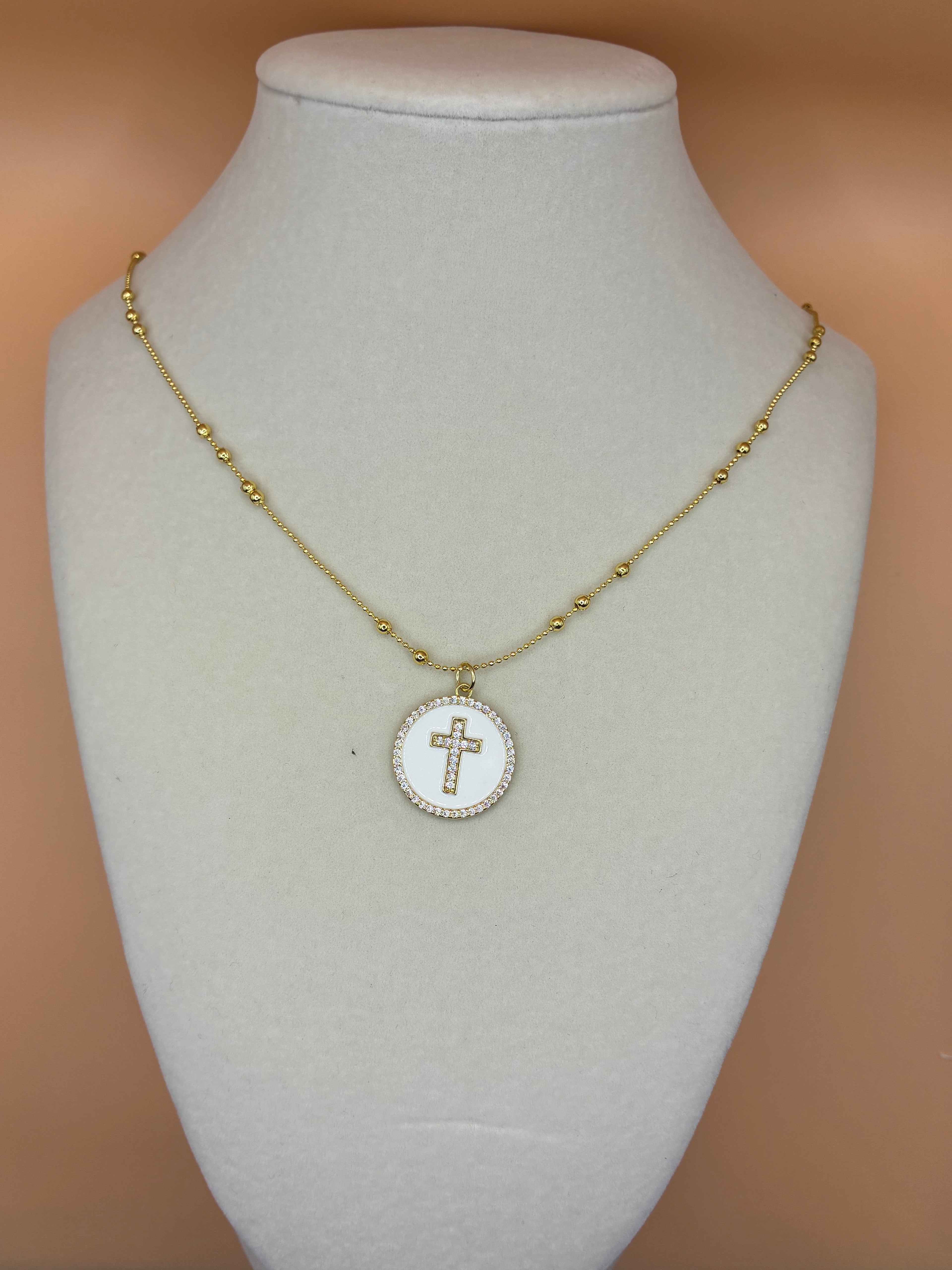 Cross charm on gold necklace